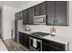 A modern kitchen showcases stainless steel appliances and dark cabinets with sleek hardware at 12547 Lake View St, Longmont, CO 80504