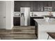 A stainless-steel refrigerator and dark cabinets accent this home's spacious and modern kitchen at 12547 Lake View St, Longmont, CO 80504
