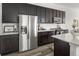 Modern kitchen with stainless steel appliances and dark cabinets providing elegance at 12547 Lake View St, Longmont, CO 80504