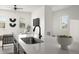 Modern kitchen with white countertops, dark cabinetry, and stainless steel appliances, offering a sleek design at 12547 Lake View St, Longmont, CO 80504