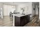 Kitchen island with dark cabinetry and stainless-steel dishwasher, plus seating at 12547 Lake View St, Longmont, CO 80504