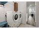 Laundry room with stacked washer and dryer, and blue bench at 12547 Lake View St, Longmont, CO 80504