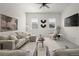 Bright and stylish living room with a ceiling fan, offering a comfortable and inviting space for relaxation at 12547 Lake View St, Longmont, CO 80504