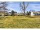 Expansive backyard with lush green lawn and mature trees offering shade and space at 3253 S Estes St, Lakewood, CO 80227