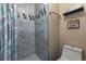Bathroom featuring a shower with marble tile and humorous wall decor at 3253 S Estes St, Lakewood, CO 80227