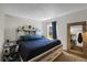 Cozy bedroom with a queen bed, storage headboard, and natural light from the window at 3253 S Estes St, Lakewood, CO 80227