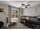Bright bedroom featuring a loft bed, ceiling fan, and cheerful, light-filled windows at 3253 S Estes St, Lakewood, CO 80227