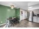 Bright dining room with green wall, stainless steel refrigerator, and tile flooring at 3253 S Estes St, Lakewood, CO 80227