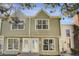 Inviting exterior of a two-story townhome with light green siding and large windows at 3253 S Estes St, Lakewood, CO 80227
