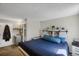 Tranquil primary bedroom featuring a queen bed, ensuite bathroom, and ample closet space at 3253 S Estes St, Lakewood, CO 80227