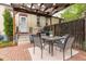 Backyard featuring a brick patio, pergola, dining set, and manicured landscaping at 4528 W 34Th Ave, Denver, CO 80212