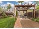 Backyard with brick walkway, pergola, patio, and lush landscaping at 4528 W 34Th Ave, Denver, CO 80212