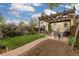 Backyard featuring a brick path, pergola, patio set, and vibrant greenery at 4528 W 34Th Ave, Denver, CO 80212