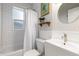 Bathroom featuring white subway tiles, a shower-tub combo, and a modern sink with stylish fixtures and decor at 4528 W 34Th Ave, Denver, CO 80212