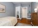 Serene bedroom with cozy twin bed, a mirror closet, and a decorative bookshelf adding a touch of personality at 4528 W 34Th Ave, Denver, CO 80212