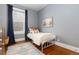 Cozy bedroom featuring a twin bed with plush bedding, a neutral color palette, and a decorative rug at 4528 W 34Th Ave, Denver, CO 80212