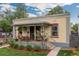 Charming front porch with twin address featuring a well-manicured lawn and colorful facade at 4528 W 34Th Ave, Denver, CO 80212