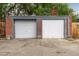 Two-car garage with white doors and brick construction, located in the backyard at 4528 W 34Th Ave, Denver, CO 80212