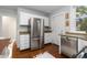 Kitchen featuring stainless steel refrigerator, granite counters, and white cabinets at 4528 W 34Th Ave, Denver, CO 80212