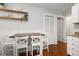 Kitchen featuring a dining table with chairs, wooden counters, and white cabinetry at 4528 W 34Th Ave, Denver, CO 80212