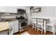 Eat-in kitchen with stainless appliances, granite counters, and a cozy dining table at 4528 W 34Th Ave, Denver, CO 80212