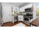 Charming kitchen with stainless steel appliances, granite countertops, and white cabinetry at 4528 W 34Th Ave, Denver, CO 80212