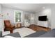 Cozy living room with hardwood floors, comfortable seating, and a view of the front door at 4528 W 34Th Ave, Denver, CO 80212