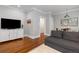 Inviting living room with hardwood floors, white trim, a modern TV, and comfortable seating arrangement at 4528 W 34Th Ave, Denver, CO 80212