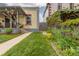 Side yard featuring lush lawn and colorful plantings, showcasing the home's exterior facade at 4528 W 34Th Ave, Denver, CO 80212