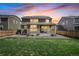 Well-maintained backyard with a lush lawn, garden beds, and a covered patio perfect for outdoor living at 14850 Oslo Ave, Parker, CO 80134