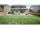 Spacious backyard with a covered patio, solar panels, and green lawn at 14850 Oslo Ave, Parker, CO 80134