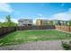 Spacious backyard with lush green grass, wood fencing, and rock border at 14850 Oslo Ave, Parker, CO 80134