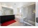 Luxurious bathroom featuring double vanity, soaking tub, and separate glass-enclosed shower at 14850 Oslo Ave, Parker, CO 80134
