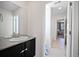 Bathroom features a single sink vanity and tile flooring with a view to the tub-shower combo at 14850 Oslo Ave, Parker, CO 80134