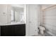 Bright bathroom with a vanity, toilet, and shower/tub combination behind a white door at 14850 Oslo Ave, Parker, CO 80134