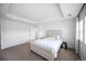 Neutral bedroom featuring a gray upholstered bed frame, tray ceiling, and carpeted flooring at 14850 Oslo Ave, Parker, CO 80134