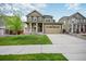 Charming two-story home with a front porch, well-kept lawn, and a two-car garage at 14850 Oslo Ave, Parker, CO 80134