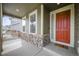 Inviting front porch featuring stone accents, a red door, and a welcome mat at 14850 Oslo Ave, Parker, CO 80134