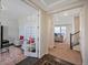 Bright hallway with a view of the living room, featuring an office space with French doors at 14850 Oslo Ave, Parker, CO 80134
