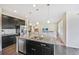 Spacious kitchen featuring granite countertops, pendant lighting, and an open view to the living area at 14850 Oslo Ave, Parker, CO 80134