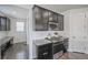 Modern kitchen with stainless steel appliances, dark cabinetry, and granite countertops at 14850 Oslo Ave, Parker, CO 80134