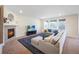 Spacious living room features a fireplace, a large sectional sofa, and lots of natural light at 14850 Oslo Ave, Parker, CO 80134
