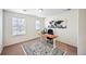 Home office with a desk, a chair, neutral walls, carpeted flooring, and natural light at 14850 Oslo Ave, Parker, CO 80134