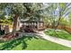 Charming backyard featuring manicured lawn, landscaping, a gazebo, and mature trees at 1462 Marigold Dr, Lafayette, CO 80026