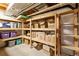 Unfinished basement storage area with wooden shelving units at 1462 Marigold Dr, Lafayette, CO 80026