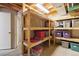 Unfinished basement storage area with wooden shelving units at 1462 Marigold Dr, Lafayette, CO 80026