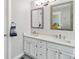 Bright bathroom featuring a double vanity with modern fixtures and stylish mirrors at 1462 Marigold Dr, Lafayette, CO 80026