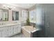Bright bathroom with a large soaking tub, double vanity, and a separate glass-enclosed shower at 1462 Marigold Dr, Lafayette, CO 80026