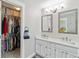 Bathroom with a double vanity and an open closet at 1462 Marigold Dr, Lafayette, CO 80026