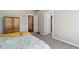 Spacious bedroom with neutral tones and multiple doorways for easy access at 1462 Marigold Dr, Lafayette, CO 80026